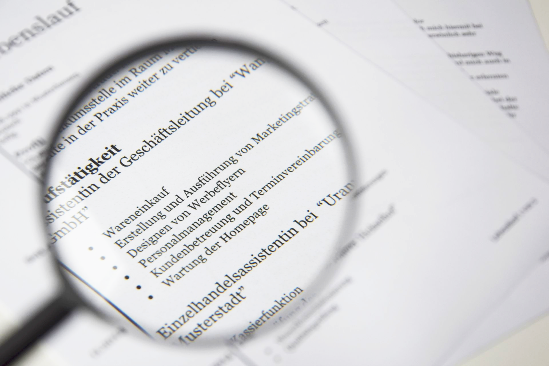 magnifying glass beside white printer paper