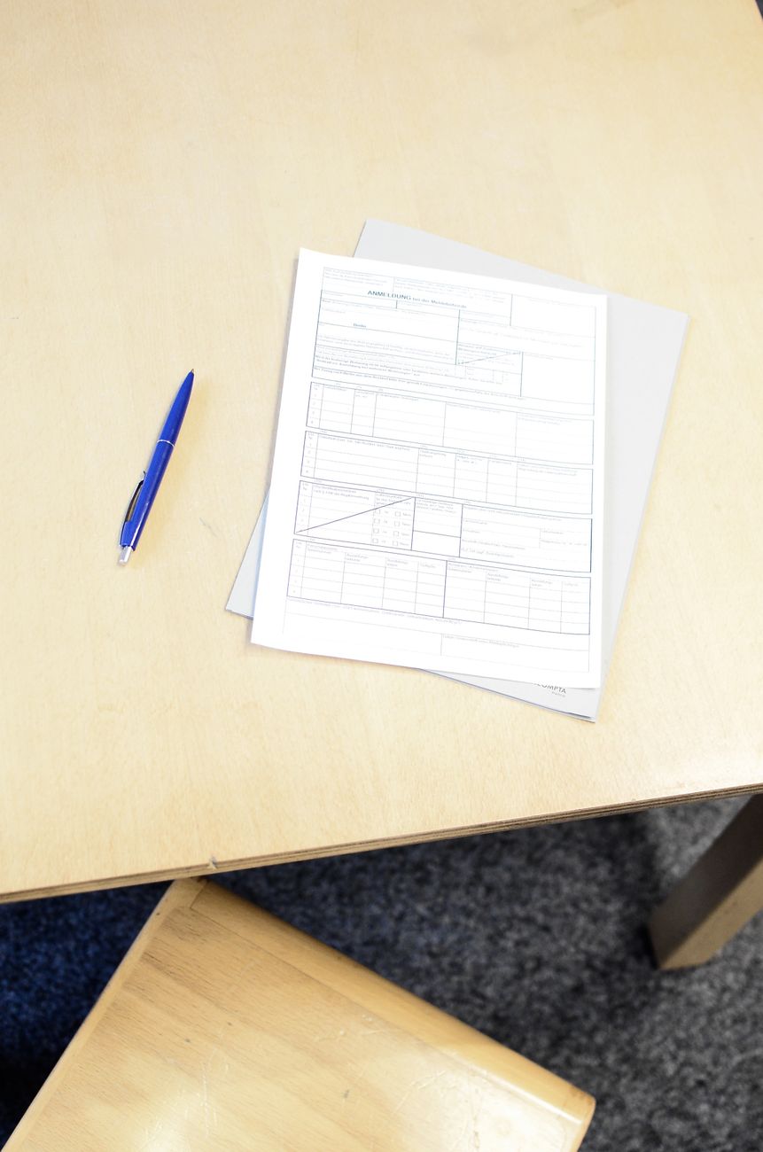registration form with pen on table in workspace